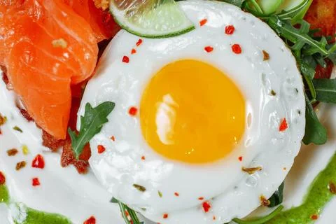 Poached eggs on top of smashed avocado on sourdough toast with smoked salmon Stock Photos
