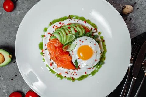 Poached eggs on top of smashed avocado on sourdough toast with smoked salmon Stock Photos