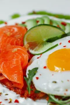 Poached eggs on top of smashed avocado on sourdough toast with smoked salmon Stock Photos