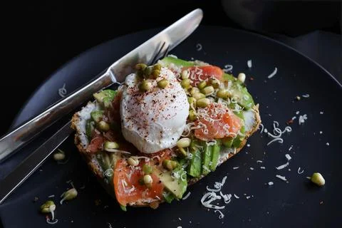 Poached eggs on top of smashed avocado on sourdough toast with smoked salmon  스톡 사진