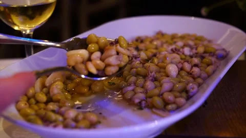 Pochas con chipirones (pochas beans and  small squid) , Spanish tapas Stock Footage 248527463