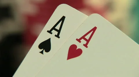 Pocket aces in a deck of playing cards with poker chips 库存影片 922891