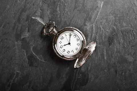 Pocket gray clock on dark gray Stock Photos