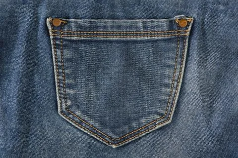 Pocket of old jeans. Empty back pocket of old blue jeans close-up. Stock Photos