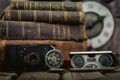 Pocket watch, blur stack of old book, hourglass, vintage binocular and world Stock Photos