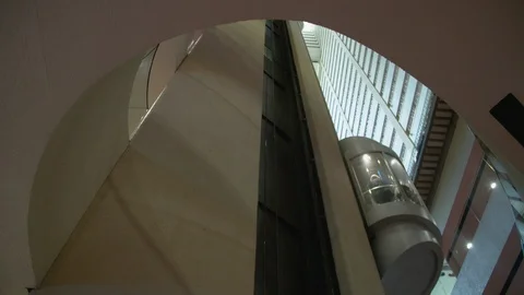 Pod style elevators go up and down in the New York City Marriott Marquis Stock Footage 99262292