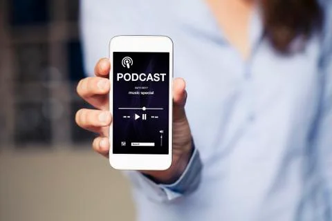 Podcast app in a phone screen while woman holds it in the hand. Stock Photos