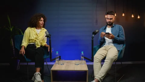Podcast presenters having engaging conversation during live broadcast Stock Footage 318192586