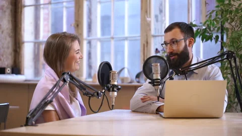 Podcast programme recording guy host talks to lady guest Spbas Video stock 158519504