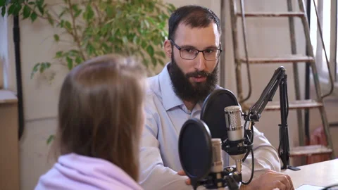 Podcast programme recording host listens to woman guest Spbas Video stock 158519492