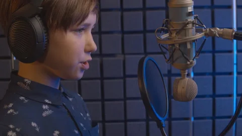 Podcast recording. Streaming platforms. Kid recording the program. An Stock Footage 138965894