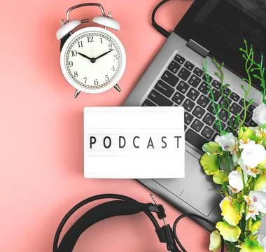 Podcast text on the lightbox, flat lay and creative background for broadcasti Stock Photos