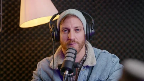 Podcaster nodding and smiling while listening to a guest. Engaged expression Video stock 299874028