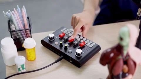 Podcaster operating audio mixing console with red knobs while recording sho.. Stock-Footage 336950252