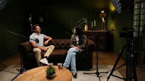 Podcasters interviewing guests in a professional recording studio 库存照片