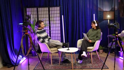 Podcasters recording a talk show interview in a professional studio Stock Footage 328633589