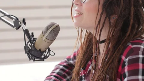 Podcasting and radio concept. Radio host young woman in the studio in front of a Stock Footage