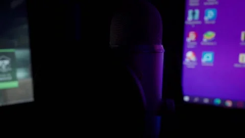 Podcasting microphone in front of flickering pc screen Stock Footage 229944649