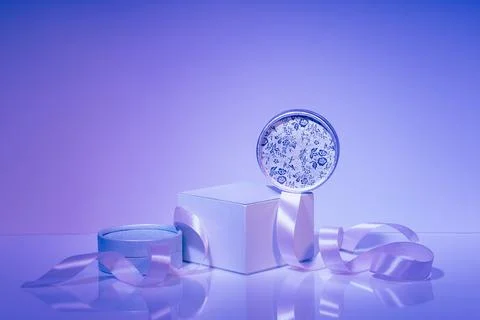 Podium, assorted gift boxes with satin ribbon on purple background Stock Photos