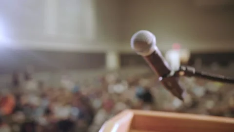 Podium microphone in a full auditorium Stock Footage 139320930