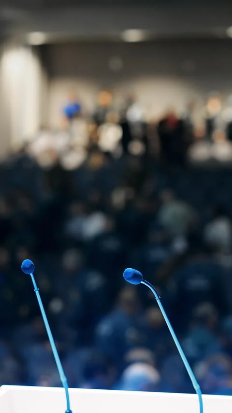 Podium Microphones Facing Large Audience at Conference Stock Footage 345559035
