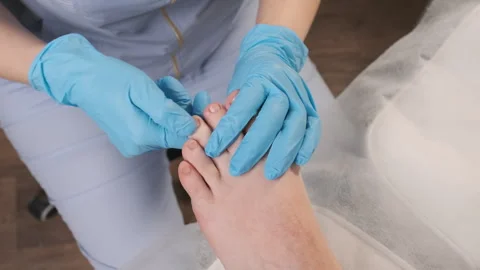 Podologist doing massage of toes for woman in beauty salon. Stock Footage 272772953