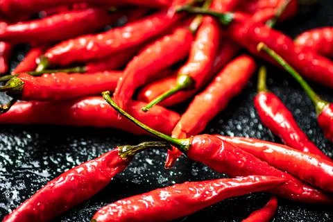 Pods of hot chili peppers on the table. Stock Photos