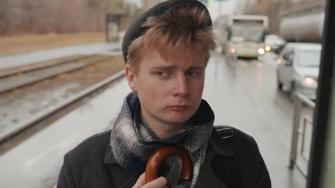 Poet observes rainy cityscape. Creative individual absorbing quiet moments Stock Footage 345177004