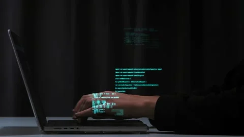 Pogrammer's hands quickly type computer code on a laptop keyboard. Hologram code Stock Footage 221642797
