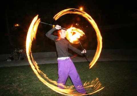 Poi dancer performing fire dance Stock Photos