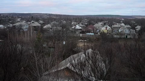 A poignant contrast: A beautiful sunset over a Ukrainian village scarred by the Stock Footage 314087818