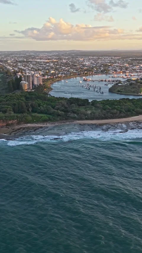 Point Cartwright Lighthouse on rocky headland aerial sunset, Sunshine Coast.. Stock Footage 334785651