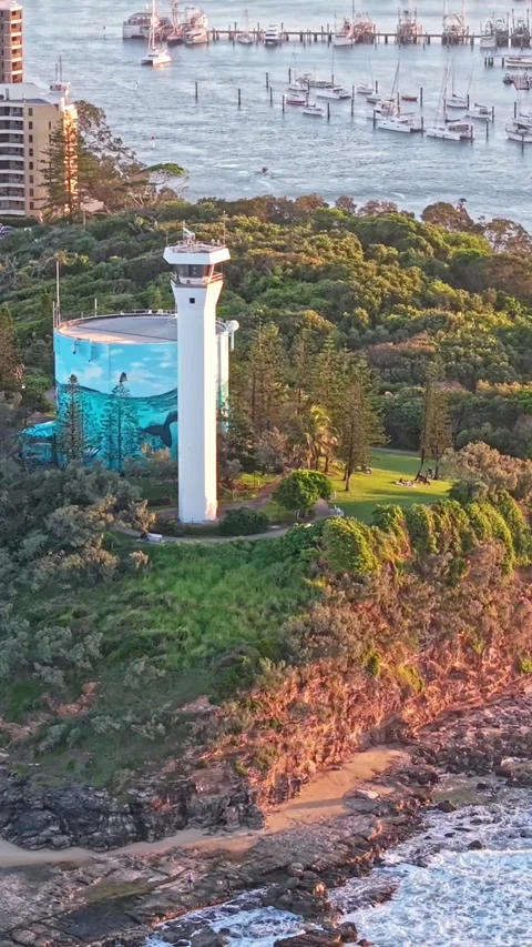 Point Cartwright Lighthouse on rocky headland aerial sunset, Sunshine Coast.. Video stock 334785663