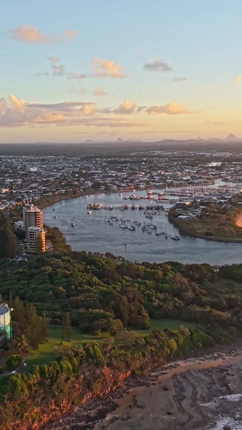 Point Cartwright Lighthouse on rocky headland aerial sunset, Sunshine Coast.. Video stock 334785698
