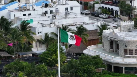A Point-Of-Interest aerial shot orbiting a waving Mexican flag, surrounded by Stock-Footage 321503100