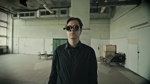 Point of interest shot: Man on a steampunk glasses. Old abandoned USSR printing 스톡 동영상 169294432