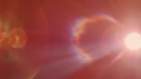 A point light source generates color rays and flares on a black background Stock Footage 313173988