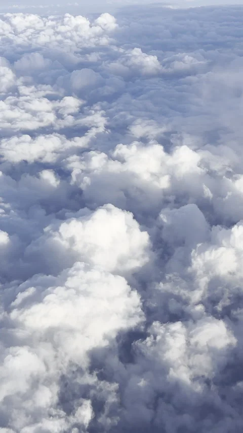 Point of view aerial above the clouds airplane passenger vertical format Stock Footage 316824283