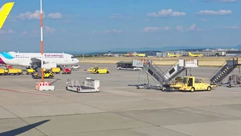 Point-of-view from airplane window showing aircraft taxiing on airport apro.. Video stock 338346555