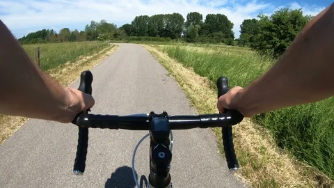 Point of view from bicycle ride on small road in the summer Stock Footage 98227474