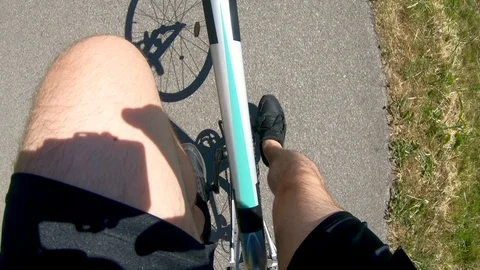 Point of view of bike rider using the pedals to ride fast Stock Footage 98226244