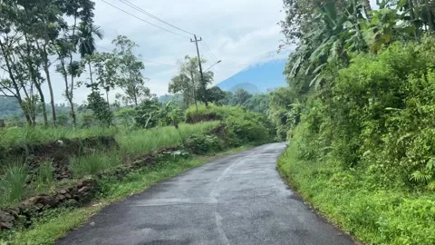 Point of view from bikers riding passes a sharp decline rural road. Video stock 314314151