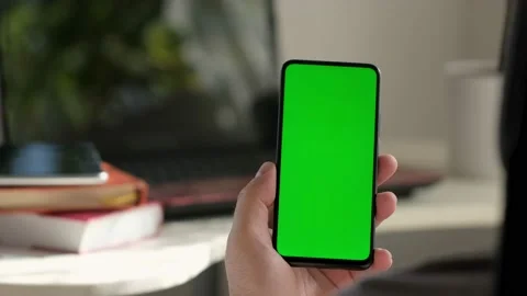 Point of View of business man using smartphone viewing green screen on mobile ph Stock Footage 154722114