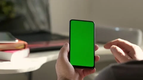 Point of View of business man using smartphone viewing green screen on mobile ph Stock Footage 154722167