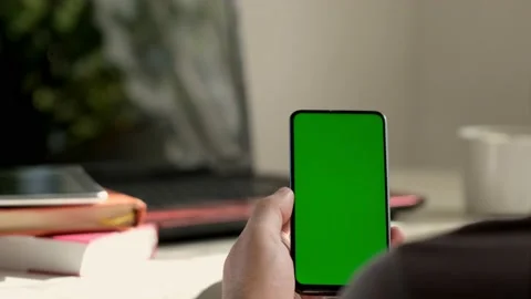 Point of View of business man using smartphone viewing green screen on mobile ph Stock Footage 154722190