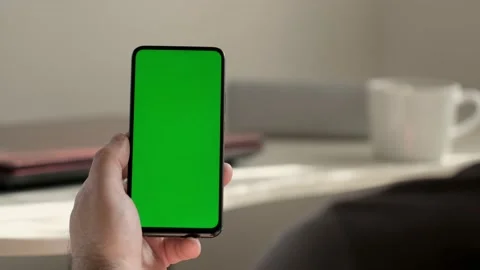 Point of View of business man using smartphone viewing green screen on mobile ph Stock Footage 154722198