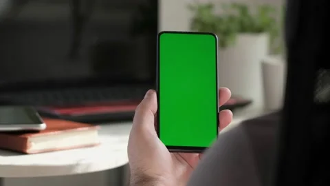 Point of View of business man using smartphone viewing green screen on mobile ph Stock Footage 154722232