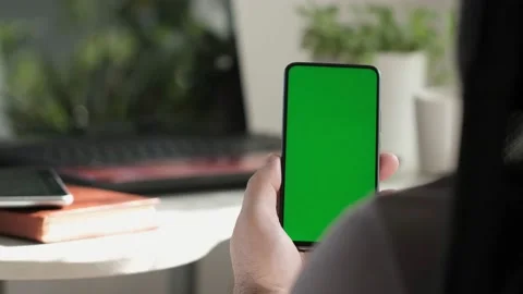Point of View of business man using smartphone viewing green screen on mobile ph Stock Footage 154722273
