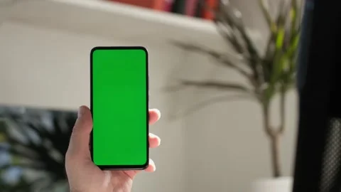 Point of View of business man using smartphone viewing green screen on mobile ph 스톡 동영상 154722320
