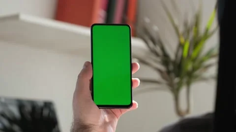 Point of View of business man using smartphone viewing green screen on mobile ph Stock Footage 154722321